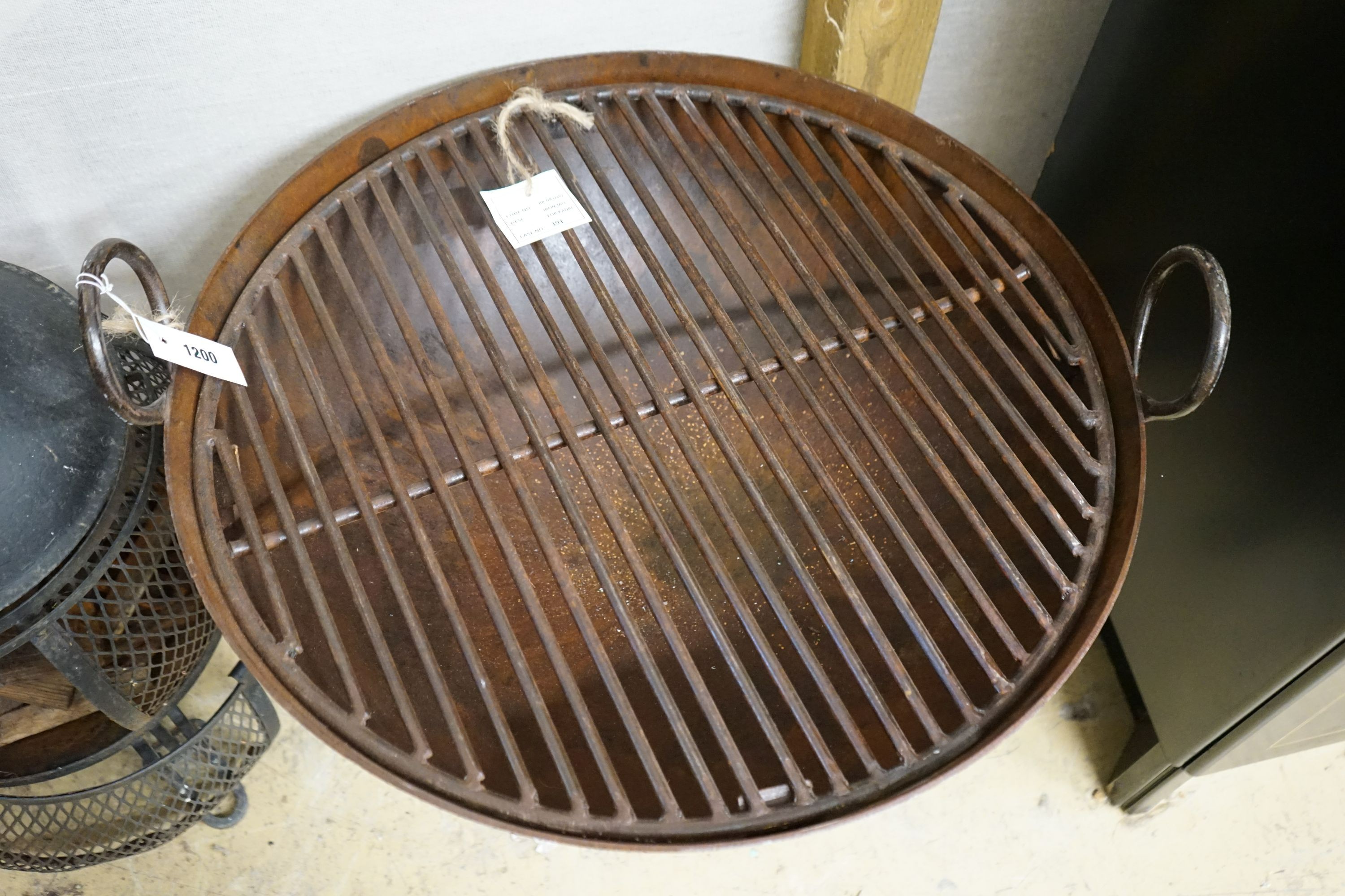 A circular wrought iron fire pit, diameter 62cm, height 67cm